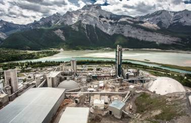 Overlooking Lafarge's Exshaw plant, body of water around the plant and the Rocky Mountains