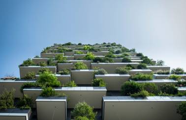 Worms-eye view of building with greenery on every balcony